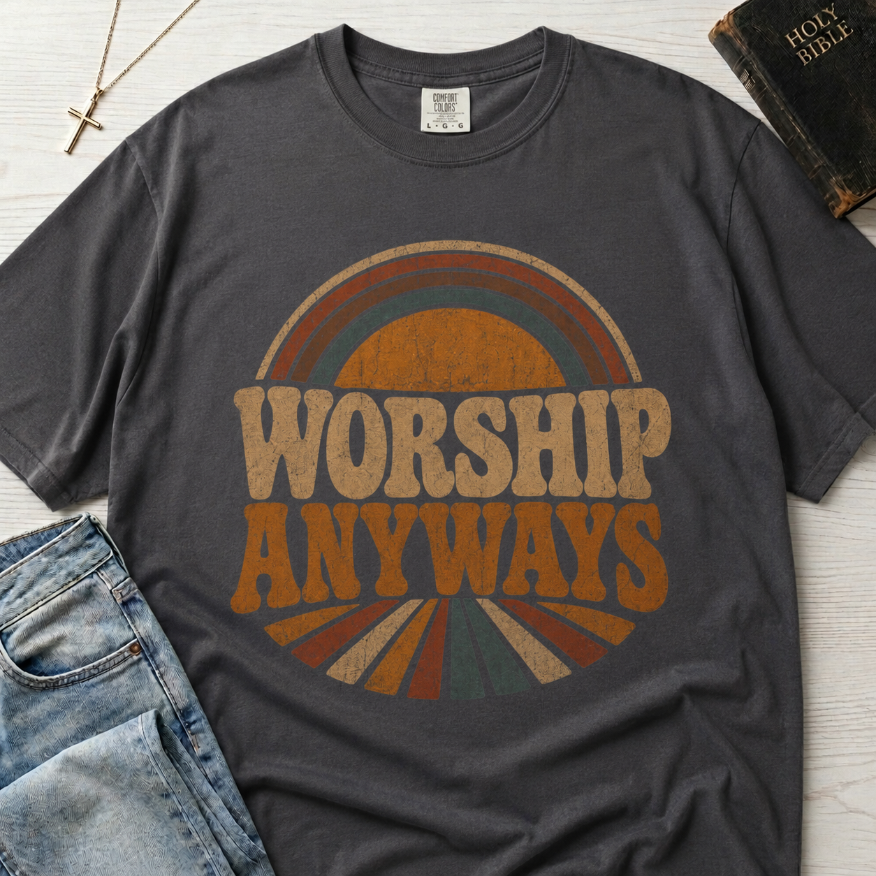 Worship Anyways Christian t-shirt in deep navy, retro 70s sunburst design with bold worship typography in warm orange and brown tones.