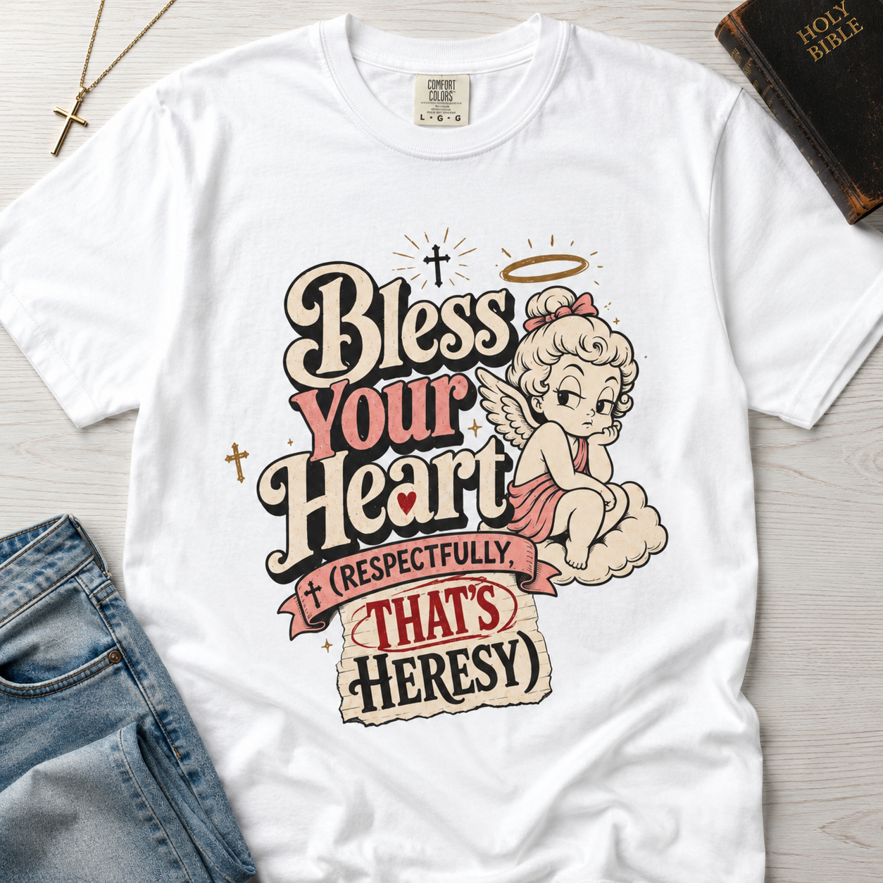 Bless Your Heart Christian humor t-shirt in white, vintage angel cartoon graphic with cheeky Southern faith-humor tagline.