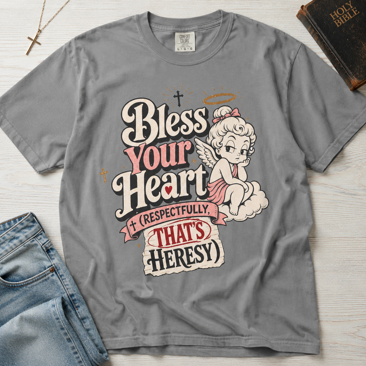 Bless Your Heart Christian humor t-shirt in heather Granite gray, retro angel graphic with cheeky 'respectfully that's heresy' Southern tagline.