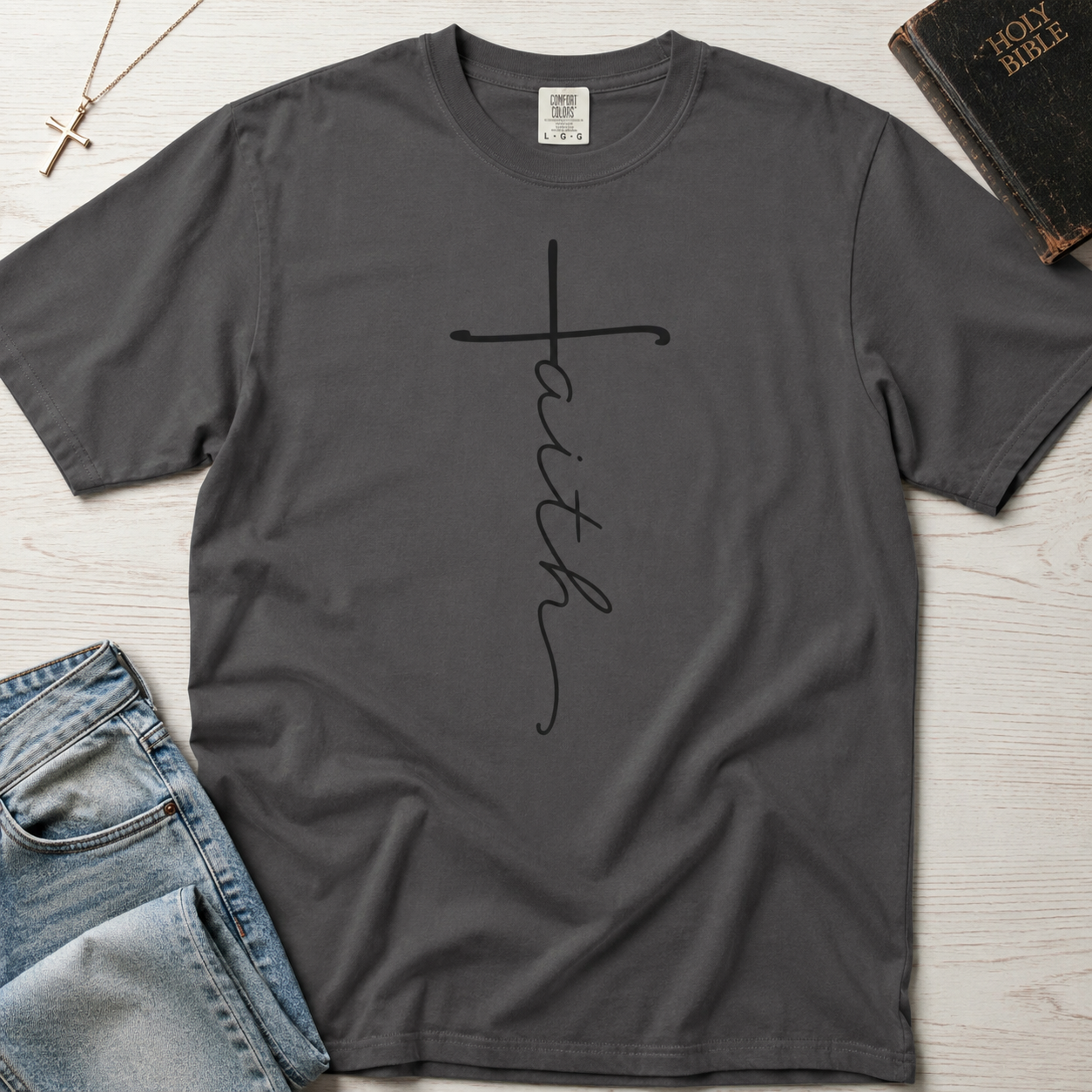 Faith vertical script Christian t-shirt in deep Graphite gray, minimal hand-lettered faith cross on garment-dyed tee.