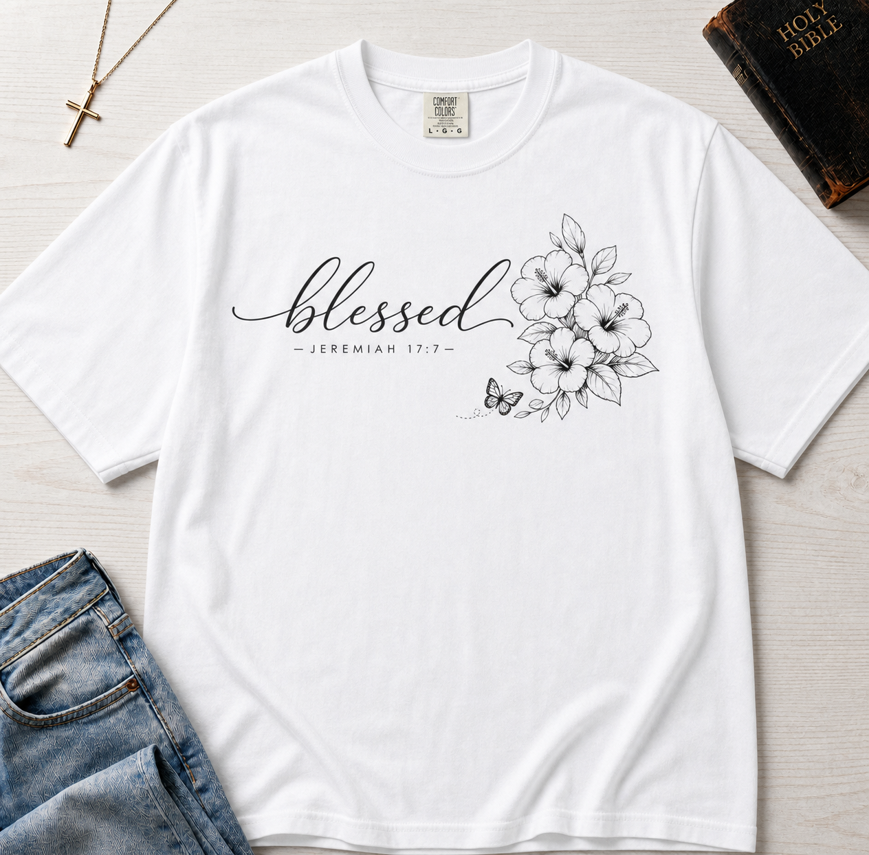 Blessed Floral Christian t-shirt in white, minimal 'blessed' cursive script with botanical floral sketch detail.