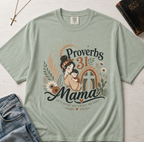 Proverbs 31 Mama Christian t-shirt in Bay sage green, vintage retro design with woman illustration, sunset and floral accents.