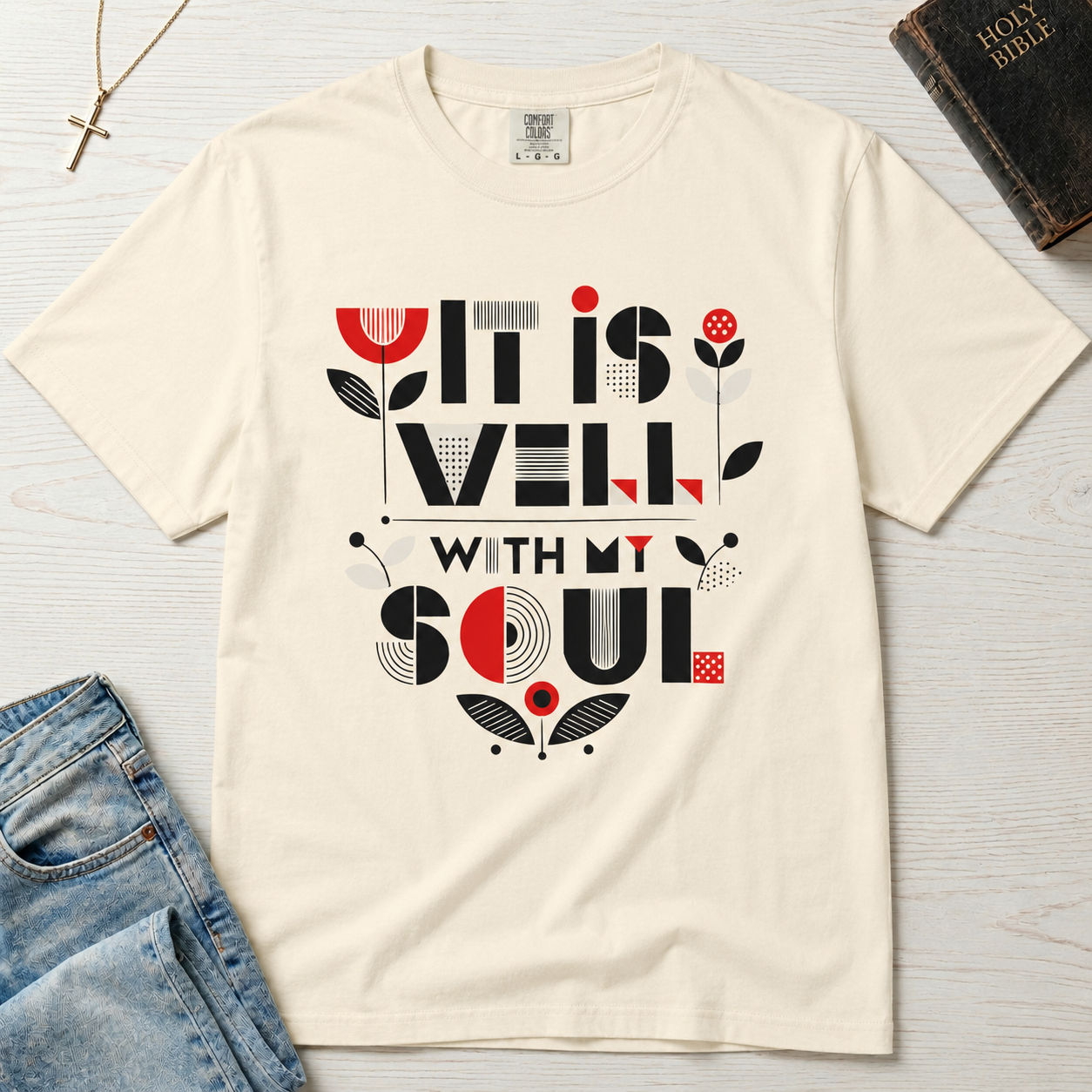 It Is Well With My Soul Christian t-shirt in ivory cream; bold geometric typography with coral tulip accents on garment-dyed faith tee.