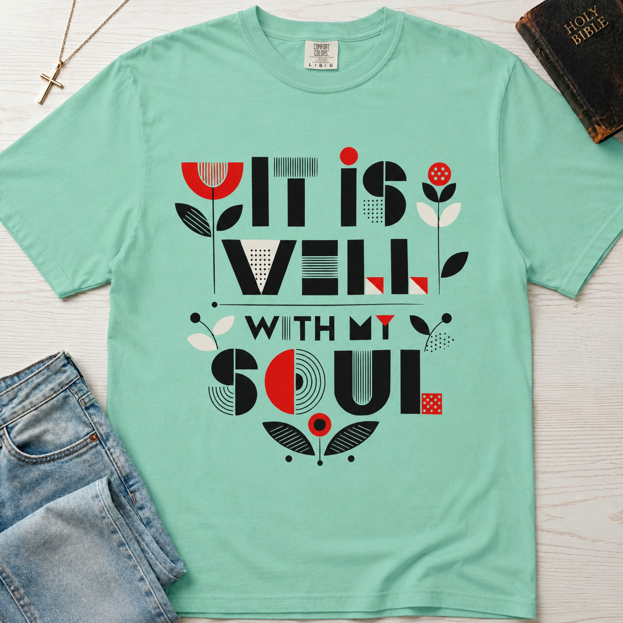 It Is Well With My Soul Christian t-shirt in mint Island Reef green; bold geometric mid-century typography with coral and charcoal tulip florals.