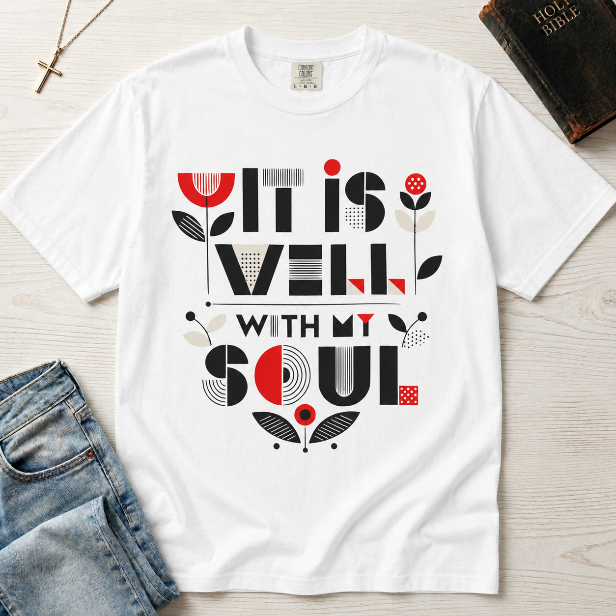 It Is Well With My Soul Christian t-shirt in white; bold mid-century geometric typography with coral tulip motifs on garment-dyed cotton.