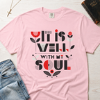 It Is Well With My Soul Christian t-shirt in pastel pink Blossom; bold typography with coral tulip floral accents on faith-inspired tee.