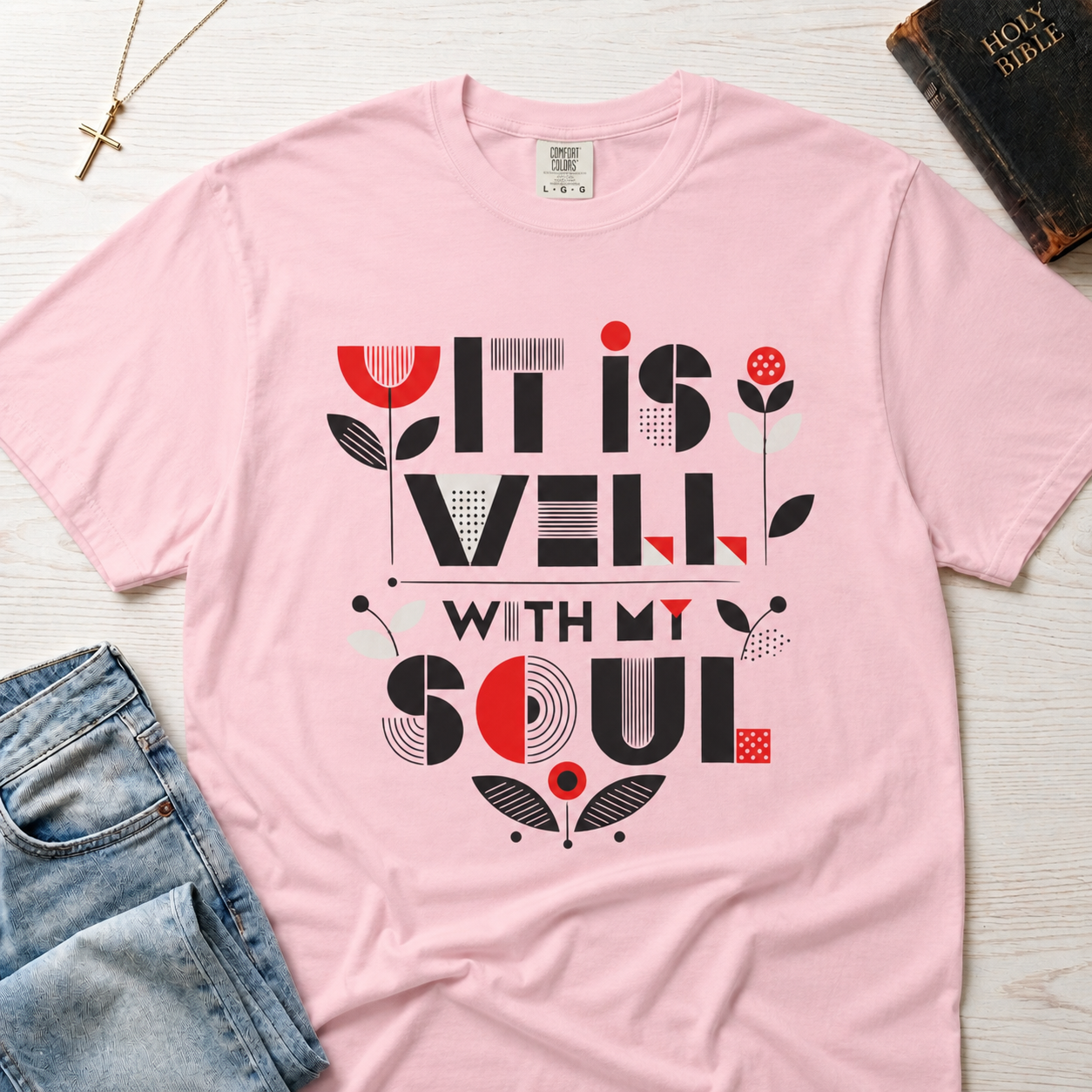 It Is Well With My Soul Christian t-shirt in pastel pink Blossom; bold typography with coral tulip floral accents on faith-inspired tee.