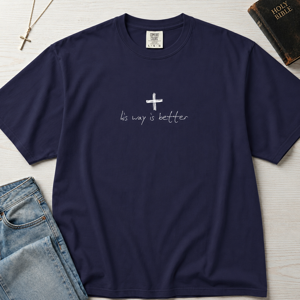 Cross & Chill minimal Christian t-shirt in deep True Navy, garment-dyed faith tee with white cross detail, flat lay with Holy Bible and cross necklace.