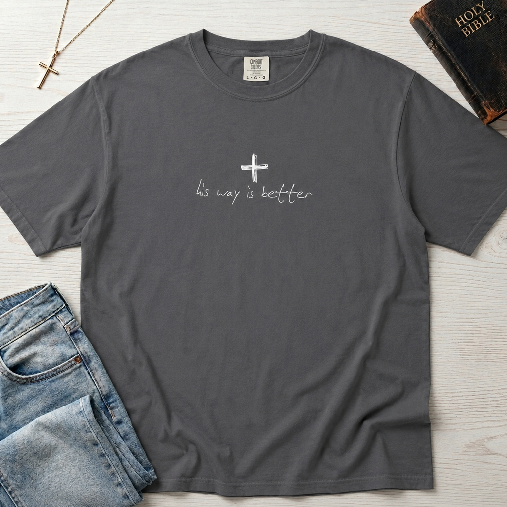 Cross & Chill minimal Christian t-shirt in heather gray, garment-dyed tee with small centered white cross and faint 'his way is better' script.