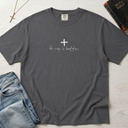 Cross & Chill minimal Christian t-shirt in heather gray, garment-dyed tee with small centered white cross and faint 'his way is better' script.