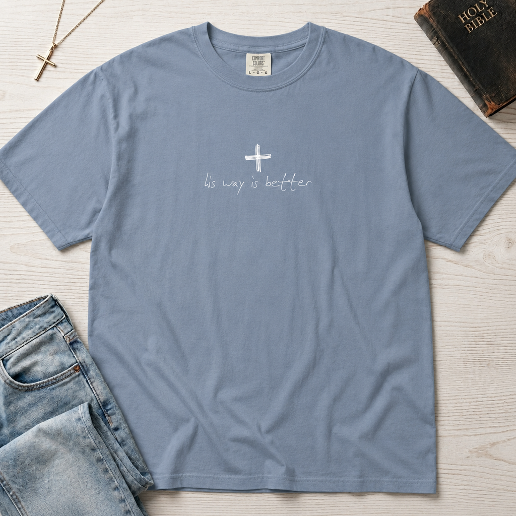 Cross & Chill minimal Christian t-shirt in dusty Blue Jean, garment-dyed tee with small white cross and minimal hand-script faith message.