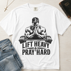 Lift Heavy Pray Hard Christian gym t-shirt in white, faith and fitness design with muscular praying lifter and barbell on garment-dyed cotton tee.