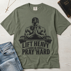 Lift Heavy Pray Hard Christian gym t-shirt in Bay sage green, faith and fitness graphic with praying lifter and barbell illustration, garment-dyed tee.