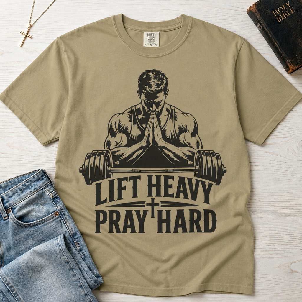 Lift Heavy Pray Hard Christian gym t-shirt in khaki sandstone, faith and fitness graphic with praying figure over barbell on garment-dyed cotton tee.