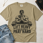 Lift Heavy Pray Hard Christian gym t-shirt in khaki sandstone, faith and fitness graphic with praying figure over barbell on garment-dyed cotton tee.