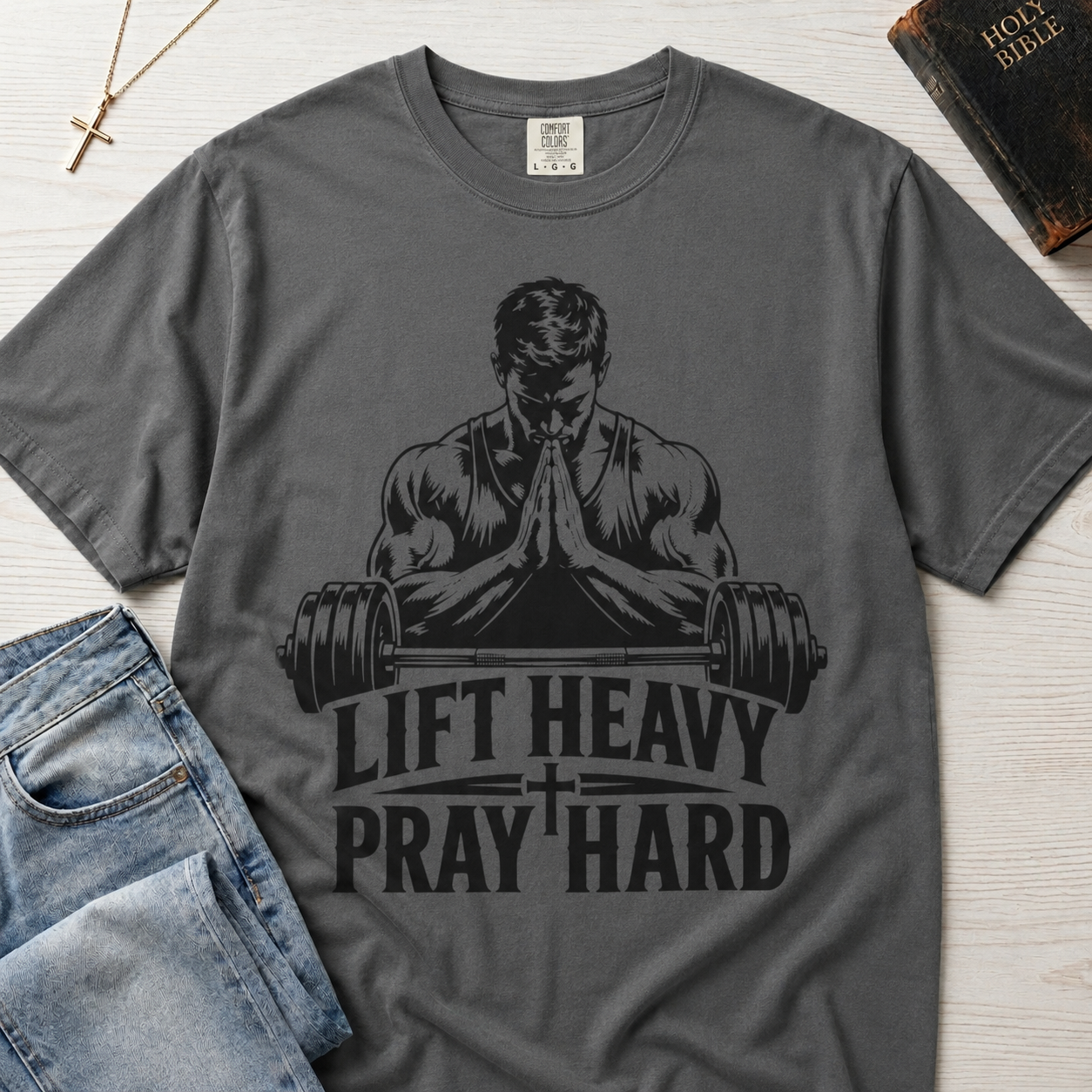 Lift Heavy Pray Hard Christian gym t-shirt in medium Granite gray, faith and fitness graphic with muscular praying figure over barbell illustration.