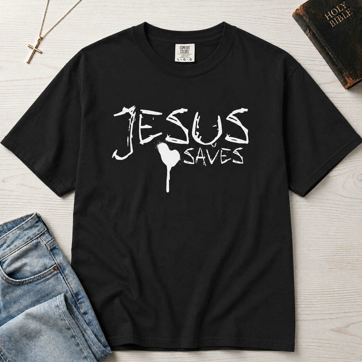Jesus Saves Christian t-shirt in deep Graphite gray, hand-painted white brushstroke faith lettering with small heart accent on garment-dyed cotton tee.