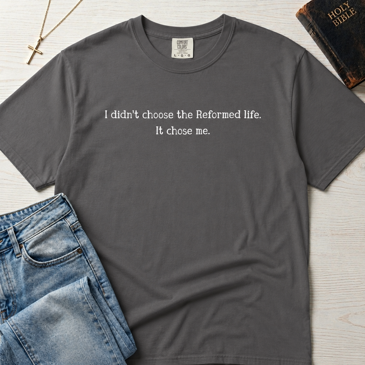 Reformed Life Christian t-shirt in light gray, garment-dyed cotton tee with minimal centered script 'I didn't choose the Reformed life. It chose me.'