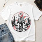 Bigfoot & Jesus Christian t-shirt in white; circular forest emblem of Jesus riding on Bigfoot's shoulders among pines with a sunburst halo.