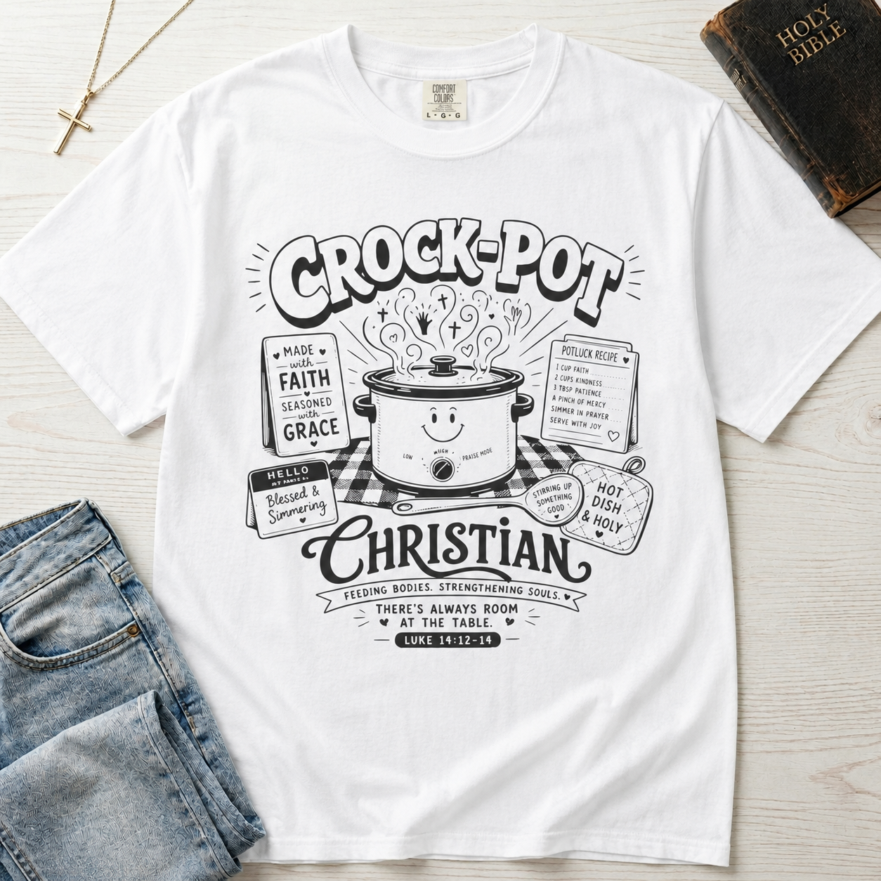 Crock-Pot Christian t-shirt in white, garment-dyed tee; retro graphic of a smiling slow cooker with 'faith' and 'grace' banners.