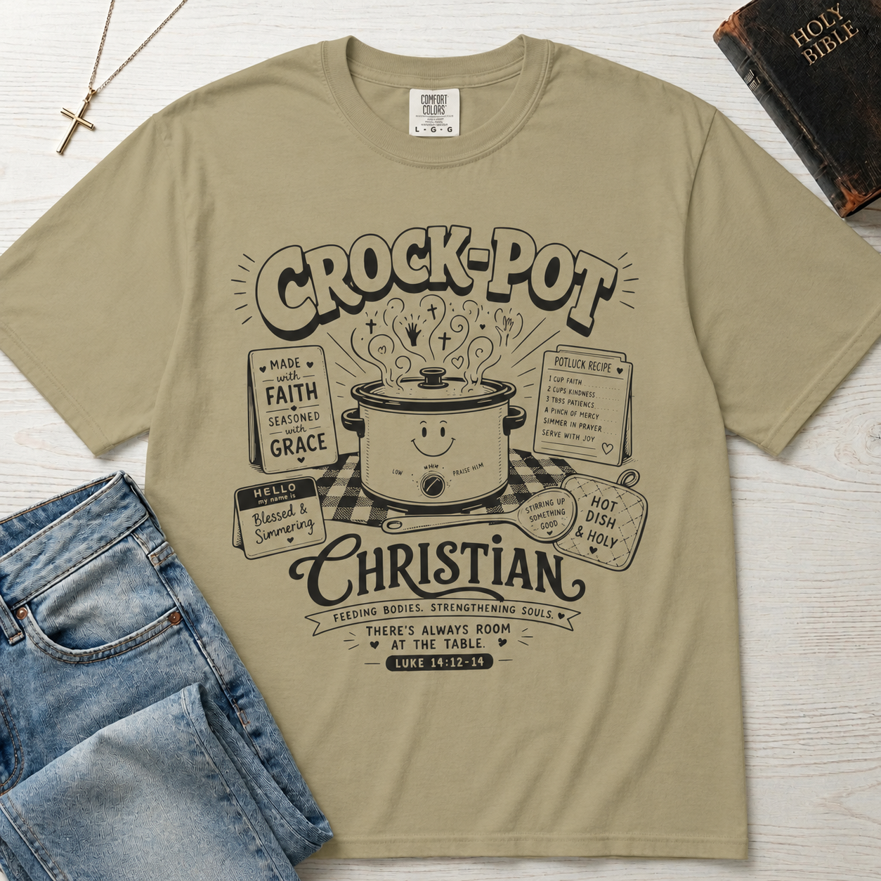 Crock-Pot Christian t-shirt in tan sand, garment-dyed tee; retro graphic of a smiling slow cooker with 'faith' and 'grace' banners.