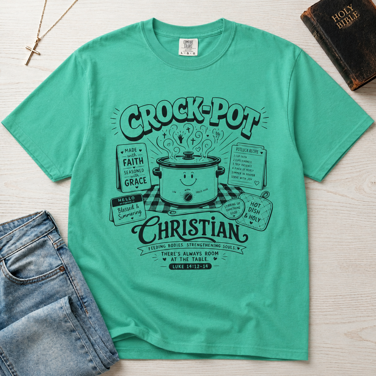 Crock-Pot Christian t-shirt in mint green, garment-dyed tee; retro graphic of a smiling slow cooker with 'faith' and 'grace' banners.