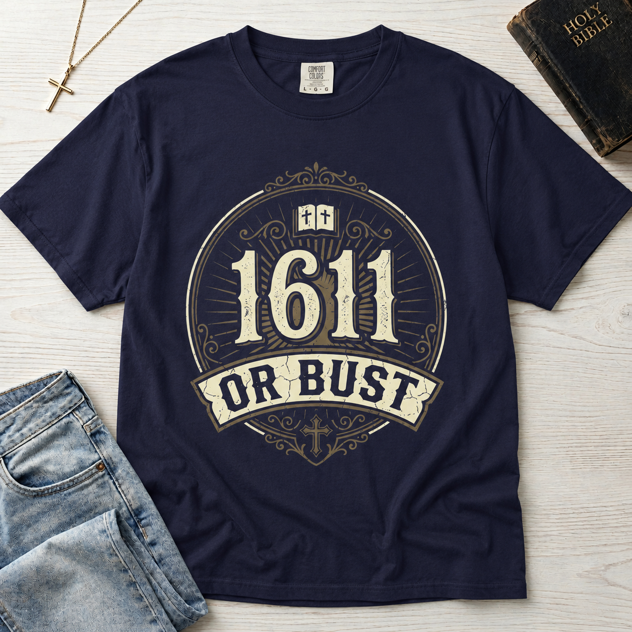 1611 Or Bust Christian t-shirt in slate blue; vintage badge with large '1611' over an 'Or Bust' banner, ornate frame with open Bible and cross.