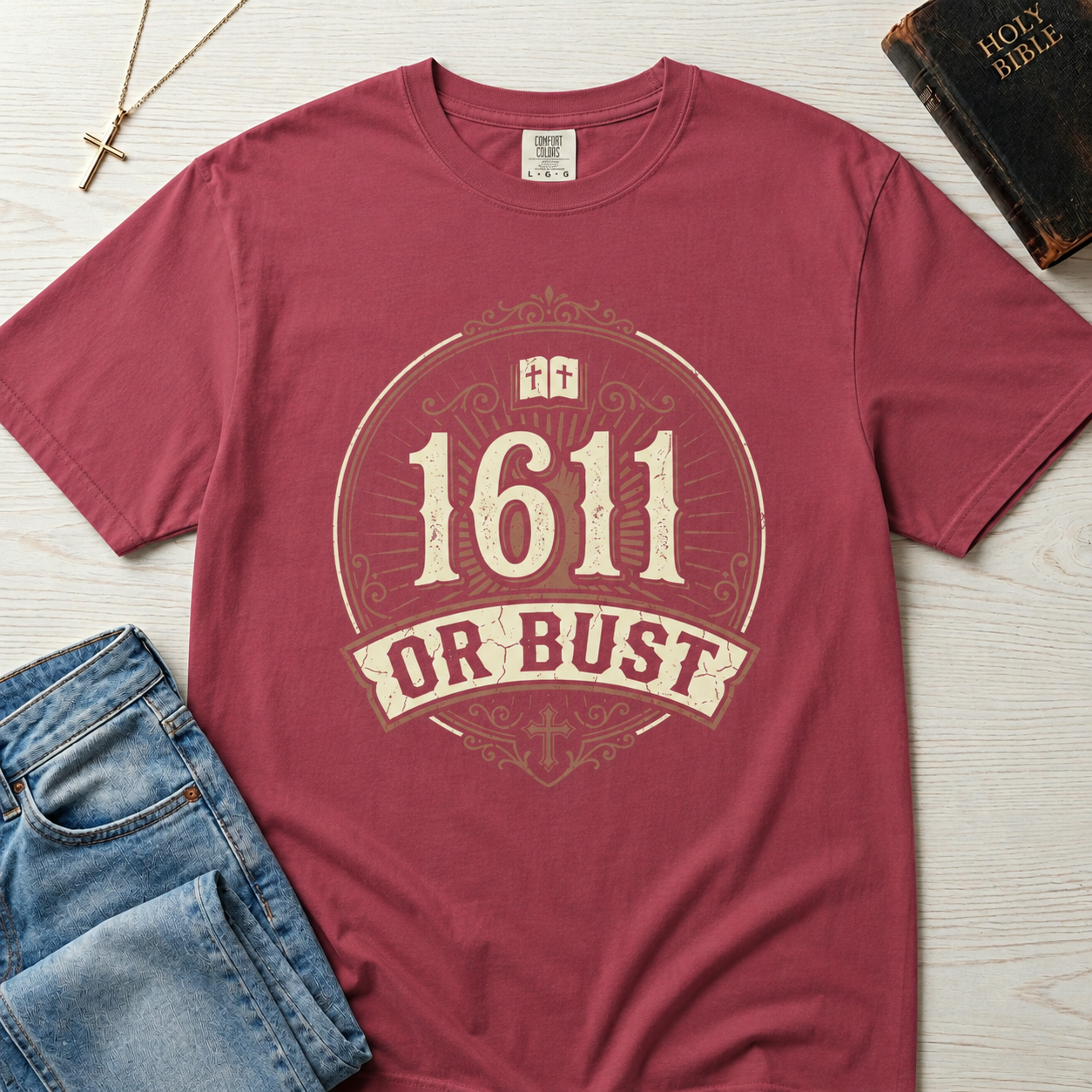1611 Or Bust Christian t-shirt in mauve rose; vintage badge with large '1611' over an 'Or Bust' banner, ornate frame with open Bible and cross.