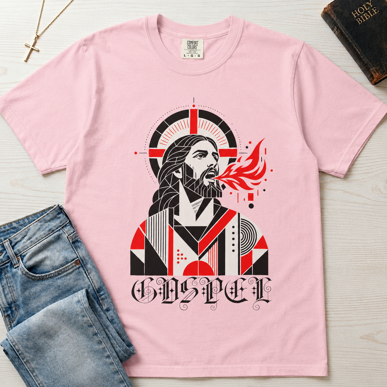 Gospel Christian t-shirt in light pink; geometric mid-century portrait of Jesus with a cross and red dove and gothic 'Gospel' lettering.