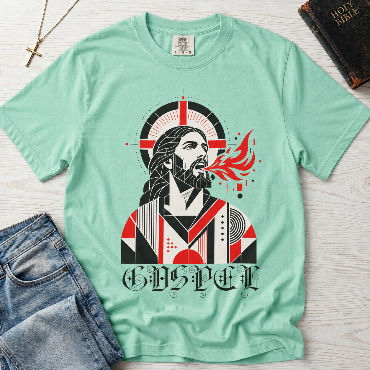Gospel Christian t-shirt in mint green; geometric mid-century portrait of Jesus with a cross and red dove and gothic 'Gospel' lettering.