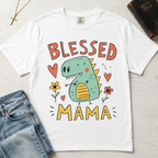 Blessed Mama Dinosaur t-shirt in white; cute cartoon green dino among flowers and hearts with 'Blessed Mama' lettering, faith mom tee.