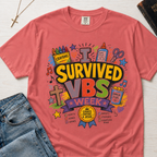 I Survived VBS Week Christian t-shirt in coral; playful graphic with crayons, cross, juice box, stars and an award ribbon, VBS souvenir tee.