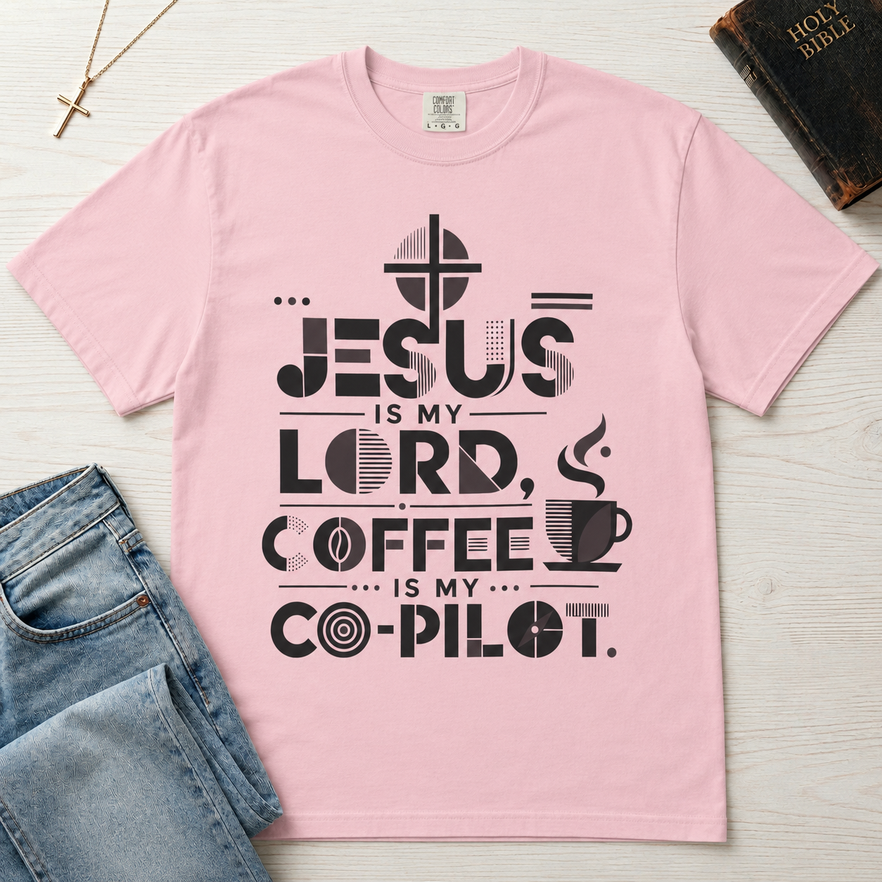 Jesus Is My Lord, Coffee Is My Co-Pilot Christian t-shirt in light pink, mid-century typography with coffee cup and cross, garment-dyed cotton tee.